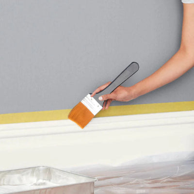 Bras femme peint plainte blanche avec pinceau mur gris