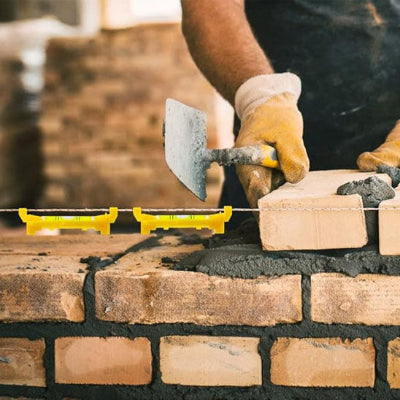 Montage mur briquette truelle niveau corde