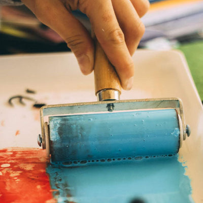 Rouleau estampage imbibe peinture bleu-à côté rouge toile